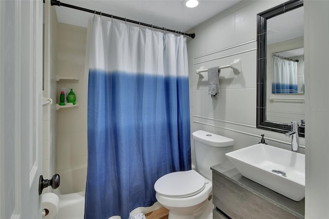 full bathroom featuring shower / bath combination with curtain, vanity, and toilet