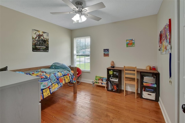 bedroom with ceiling fan and light hardwood / wood-style floors