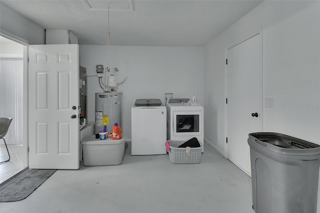 clothes washing area with gas water heater and independent washer and dryer