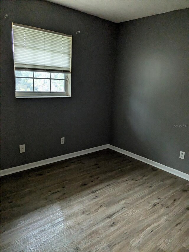 empty room with hardwood / wood-style floors