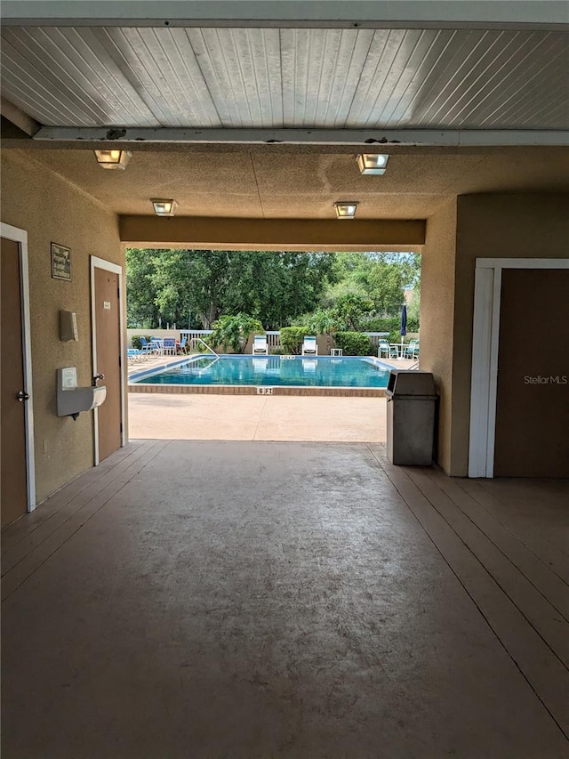 view of swimming pool with a patio