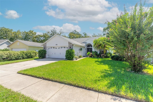 view of front of property featuring a garage and a front lawn