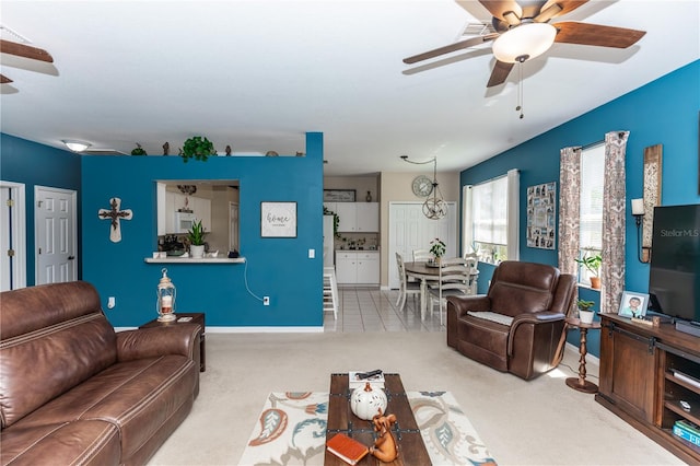 carpeted living room with ceiling fan