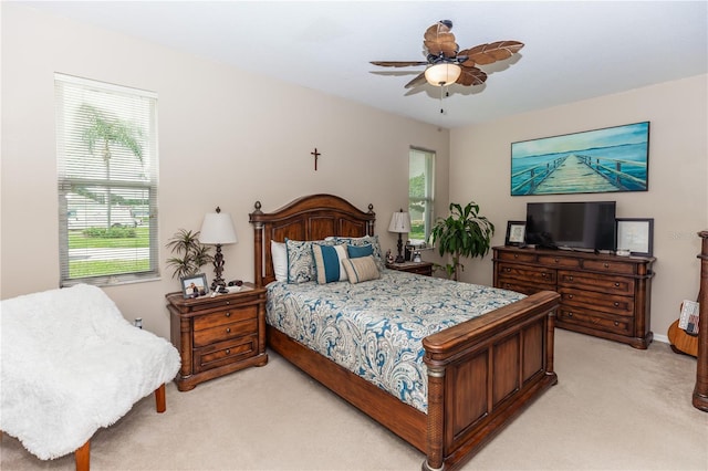 bedroom with ceiling fan and light carpet