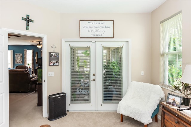 living area with french doors, light carpet, and a wealth of natural light