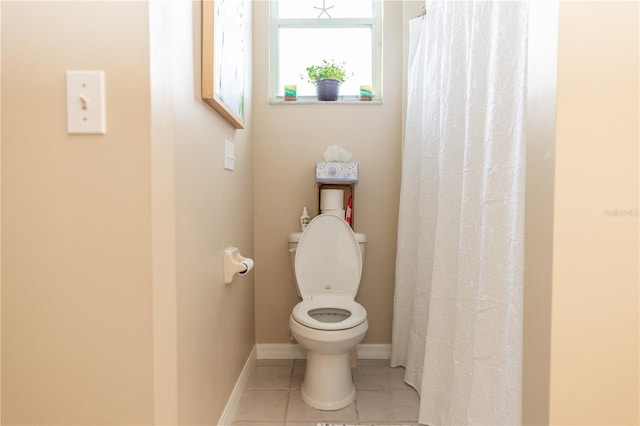 bathroom with tile patterned flooring, curtained shower, and toilet