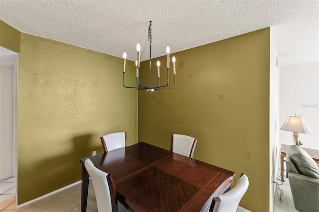 carpeted dining area featuring a chandelier and a textured ceiling