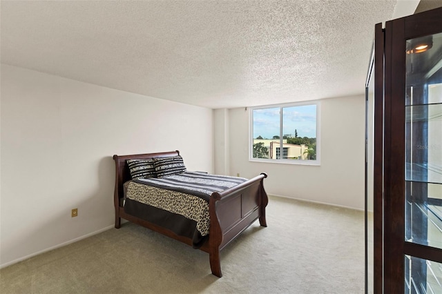 carpeted bedroom featuring a textured ceiling