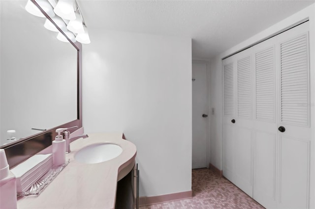 bathroom with a textured ceiling and vanity