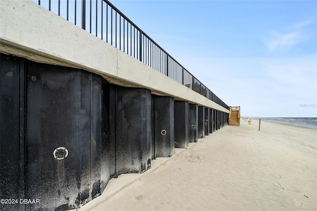 exterior space featuring a beach view and concrete floors