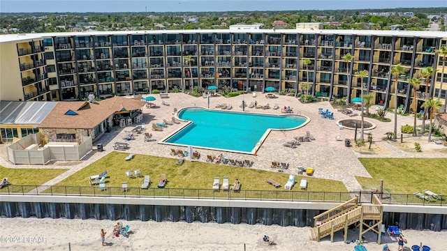 view of swimming pool featuring a lawn and a patio area