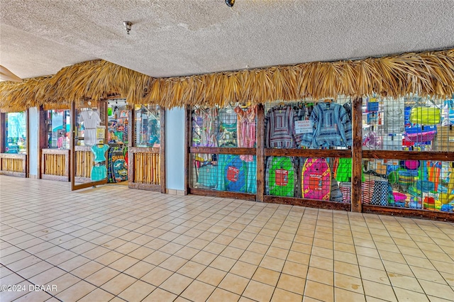 interior space featuring a textured ceiling and tile patterned flooring