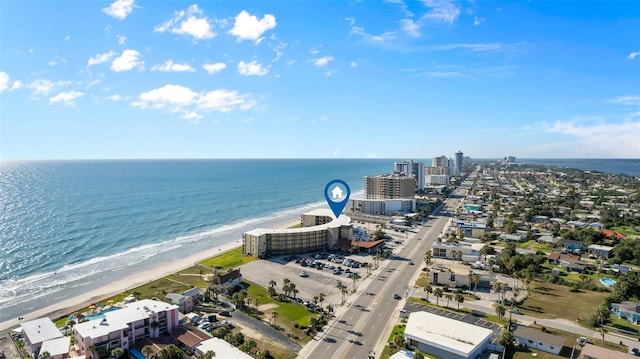 drone / aerial view with a water view and a beach view