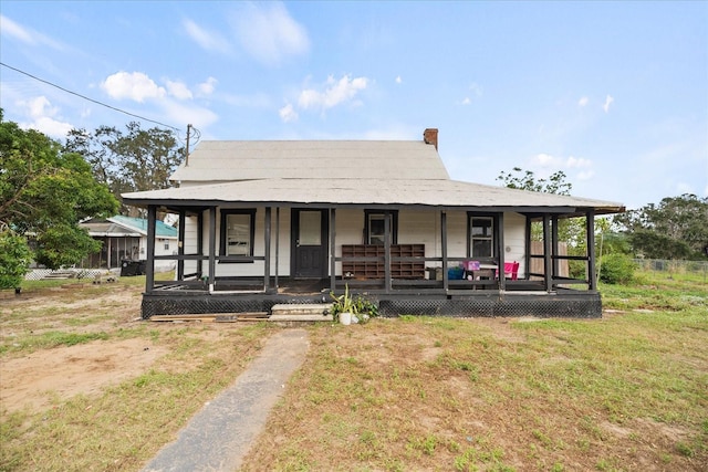 farmhouse with a front lawn and a porch