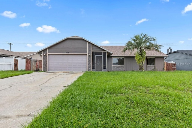 single story home with a garage and a front yard