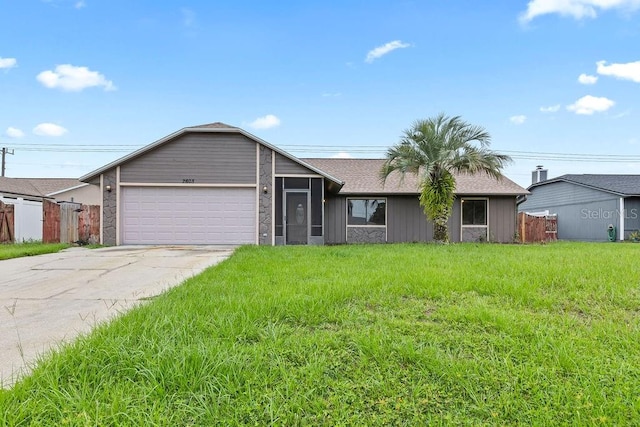 ranch-style home with a garage and a front lawn