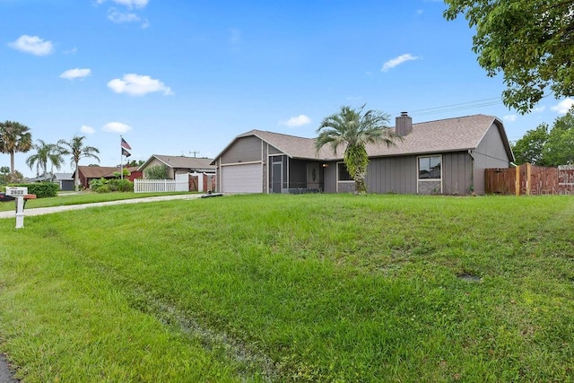 ranch-style home with a front yard and a garage