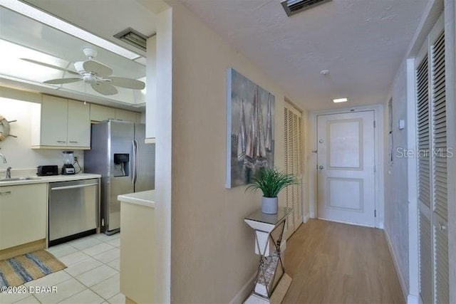 hallway featuring sink and light hardwood / wood-style floors