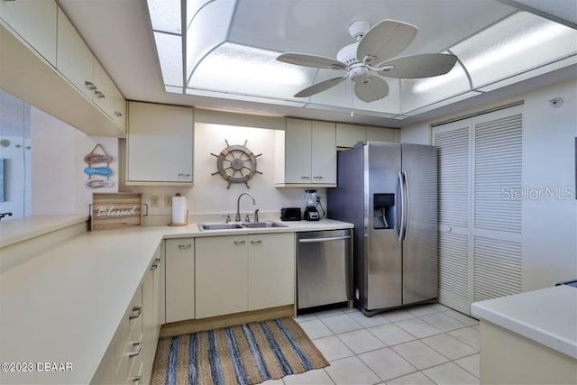 kitchen with ceiling fan, light tile patterned floors, sink, cream cabinets, and appliances with stainless steel finishes