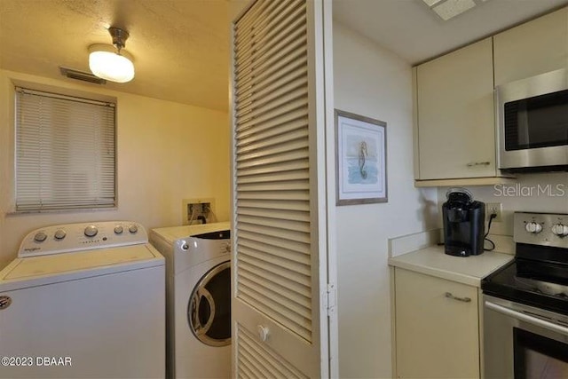 washroom with washer and dryer