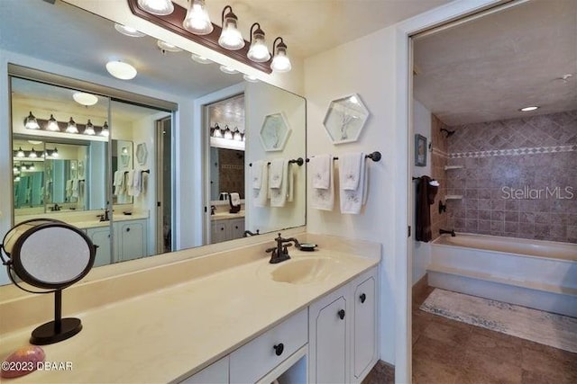 bathroom featuring vanity, tiled shower / bath combo, and tile patterned floors