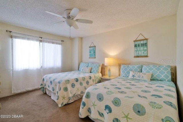 carpeted bedroom featuring a textured ceiling and ceiling fan