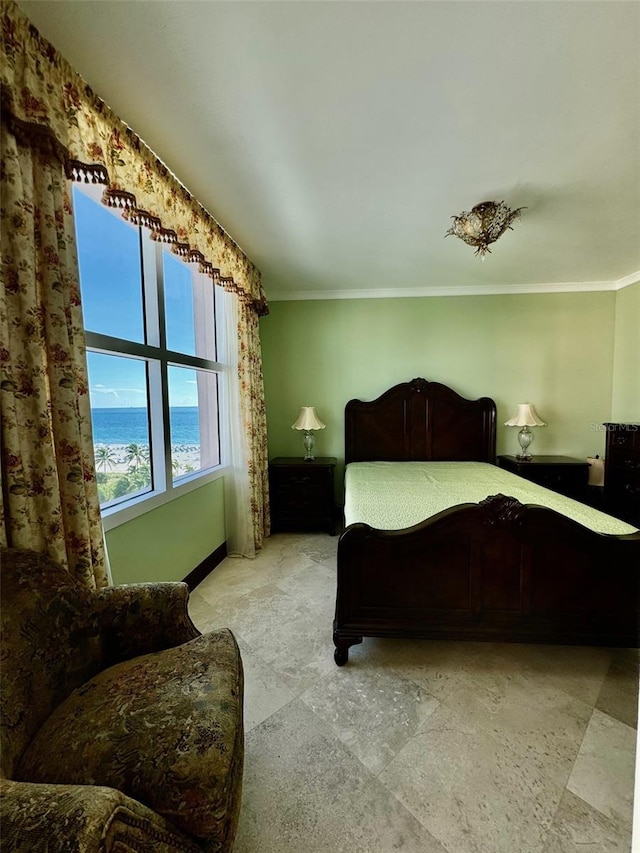 bedroom featuring ornamental molding and a water view