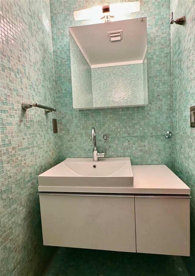 bathroom with tile walls and vanity