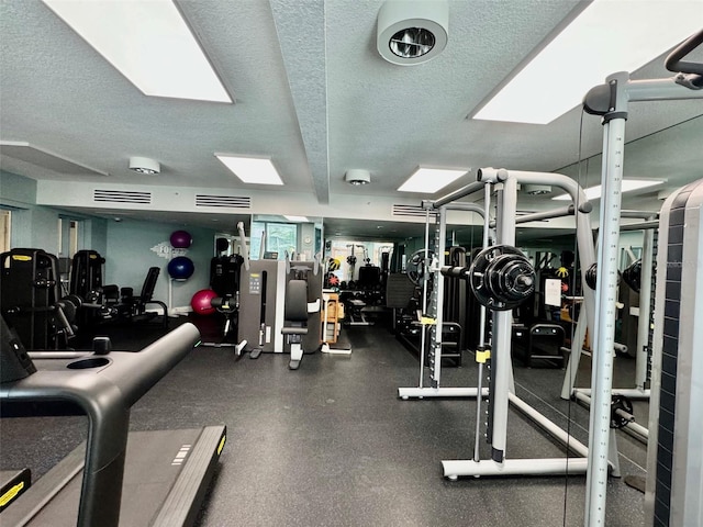 exercise room with a textured ceiling