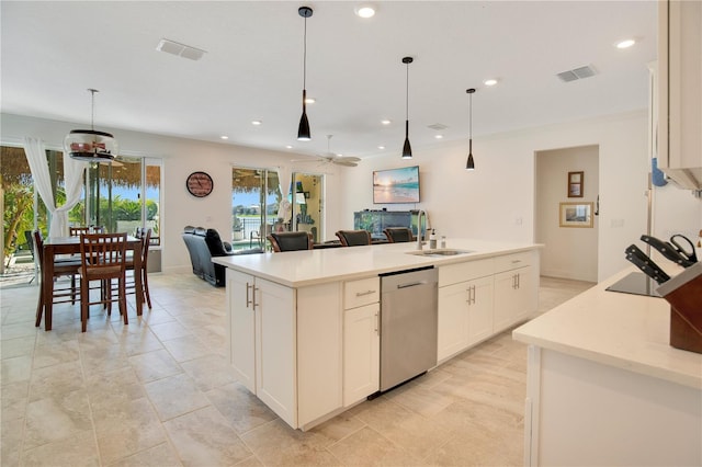 kitchen featuring sink, pendant lighting, stainless steel dishwasher, white cabinets, and a center island with sink