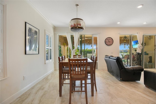 dining space featuring crown molding