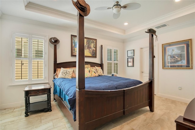 bedroom featuring ceiling fan, crown molding, and a tray ceiling