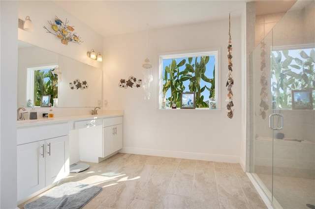 bathroom with a shower with door and vanity