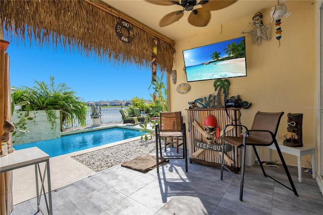 view of pool with ceiling fan and a patio area