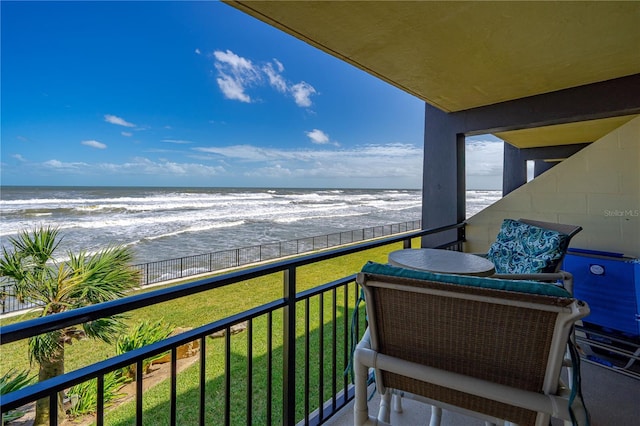 balcony featuring a water view and a view of the beach