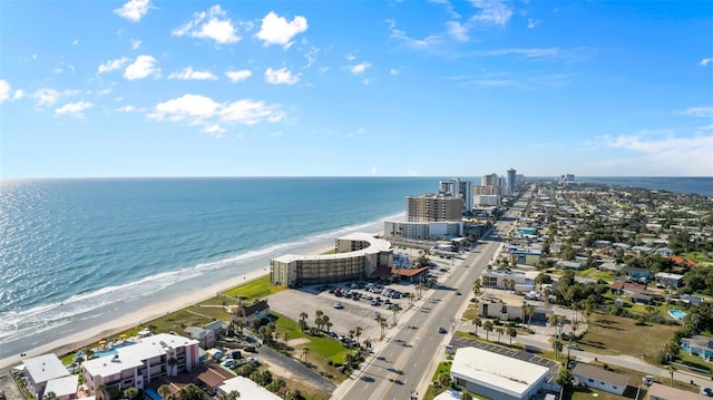 drone / aerial view with a water view and a beach view