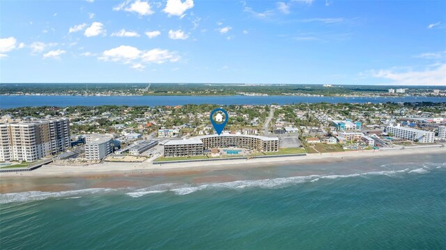 drone / aerial view featuring a water view and a beach view