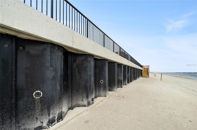 exterior space featuring a view of the beach and concrete floors