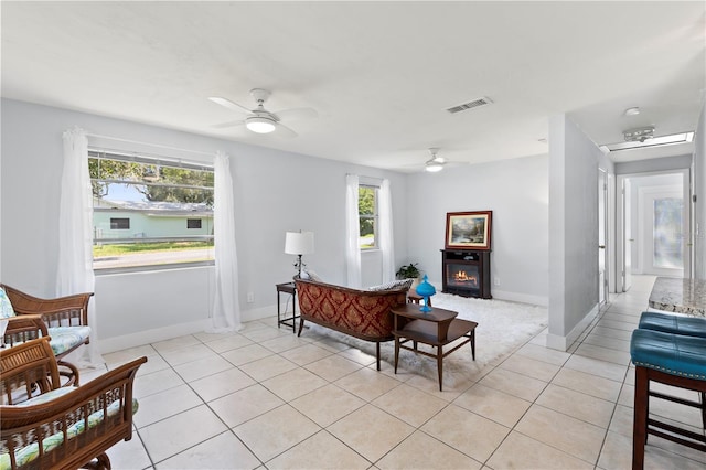 living room featuring ceiling fan and light tile patterned floors