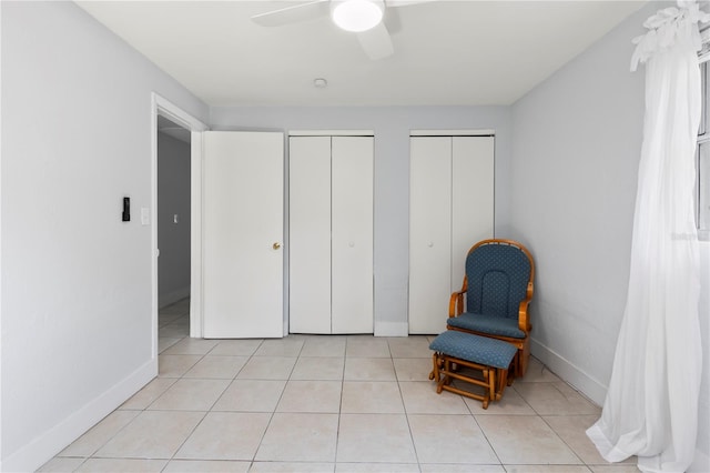 sitting room with ceiling fan and light tile patterned floors