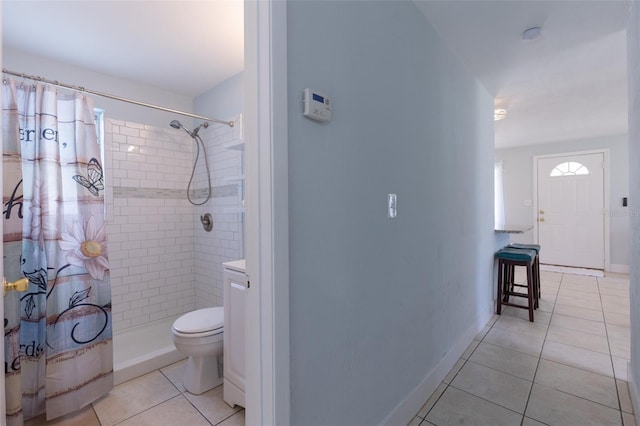 bathroom with tile patterned floors, toilet, and curtained shower