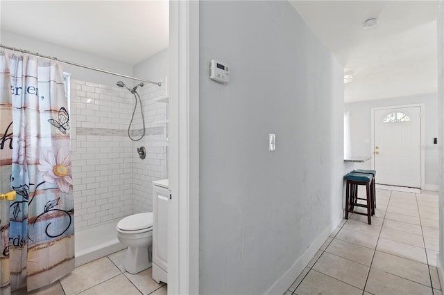 bathroom featuring vanity, tile patterned floors, toilet, and curtained shower