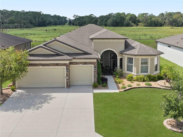 view of front of property with a front yard and a garage