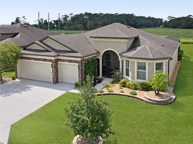 ranch-style house featuring a front yard and a garage