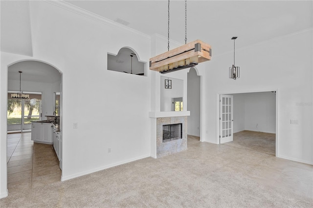 unfurnished living room with a fireplace, light colored carpet, and ornamental molding