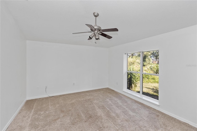 carpeted spare room with ceiling fan and a healthy amount of sunlight