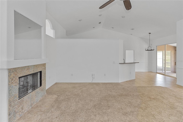 unfurnished living room with ceiling fan with notable chandelier, light colored carpet, lofted ceiling, and a tiled fireplace