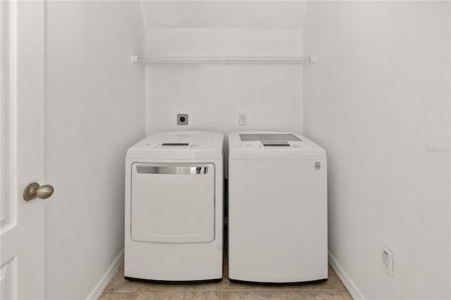 laundry area with light tile patterned flooring and independent washer and dryer