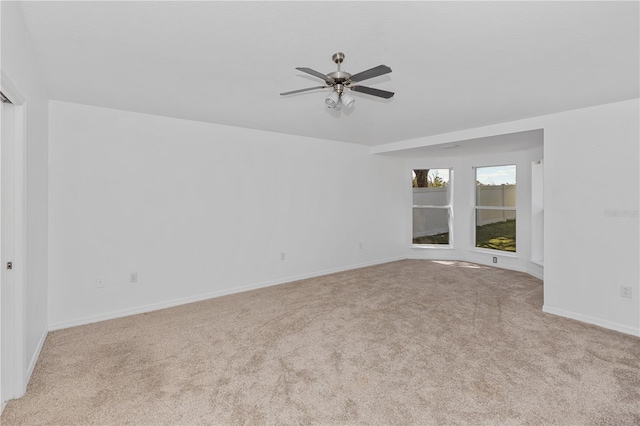 carpeted spare room with ceiling fan