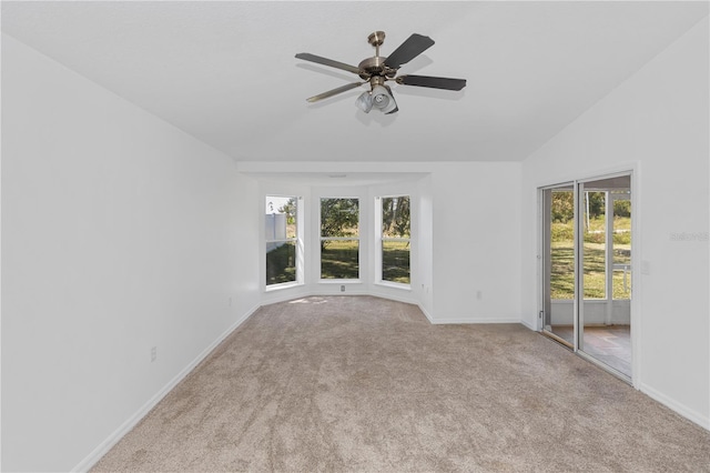 spare room with light carpet, ceiling fan, and lofted ceiling